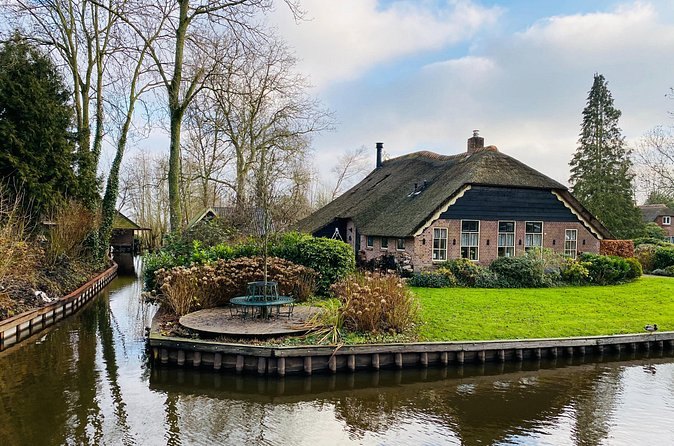 A thatched cottage on its own island beside a canal at Giethoorn
