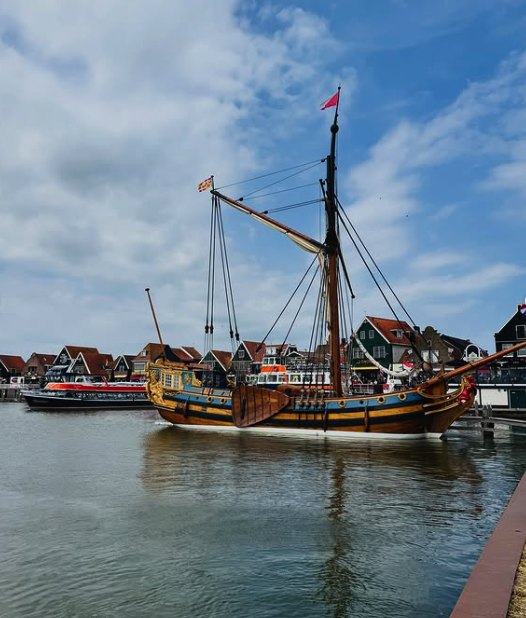 A traditional wooden sailing barge moored on the Zaan below the village