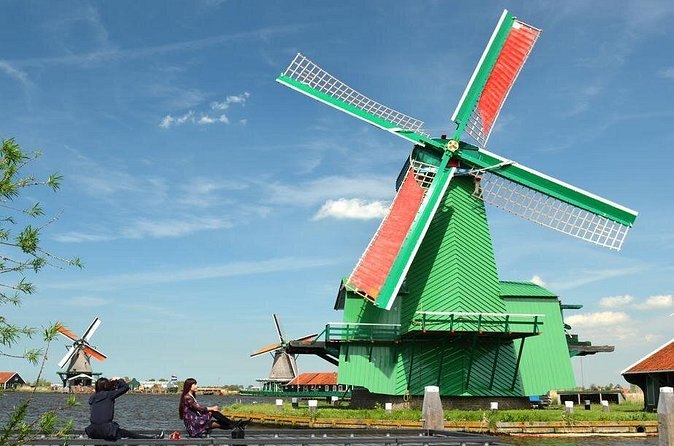 A green working sawmill at the Zaanse Schans with its sails turning
