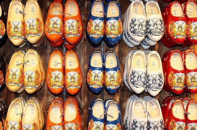 Rows of hand-painted wooden clogs on the wall of a Zaanse Schans clog workshop