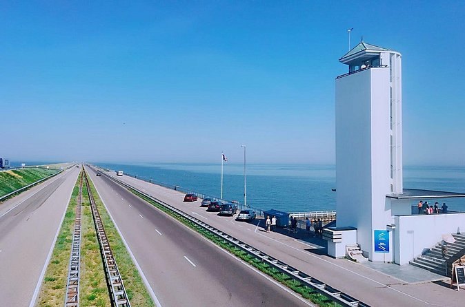 The Afsluitdijk causeway running out to sea past its monument tower