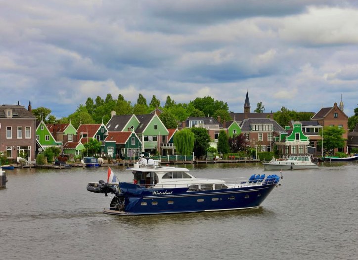 The green timber village of the Zaanse Schans seen from a boat on the Zaan