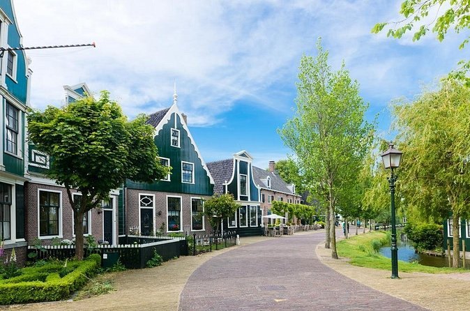 A street of green timber houses and shopfronts in the Zaanse Schans village