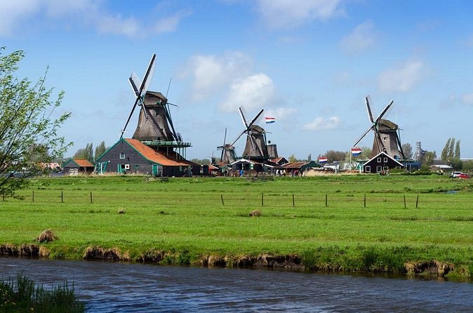 The Zaanse Schans windmills seen across a polder ditch and its meadow