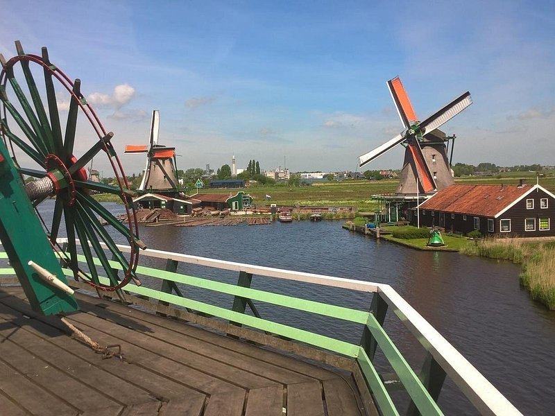 Zaanse Schans windmills seen over a wooden sluice on the Zaan