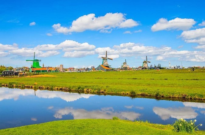 Zaanse Schans windmills reflected in the flooded grass of the polder